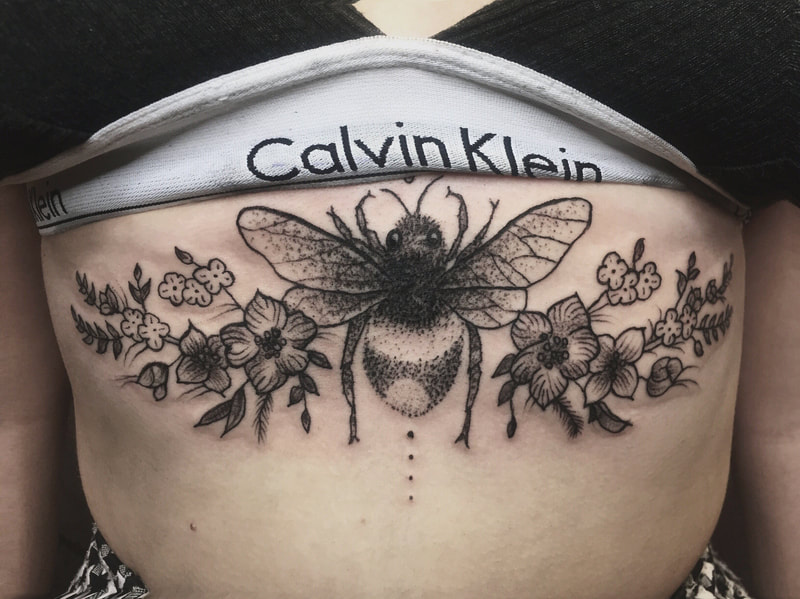 sternum tattoo black and grey bee, award winning tattoo artist, foliage flowers nature bee tattoo, symmetry design tattoo abdomen feminine tattoo.