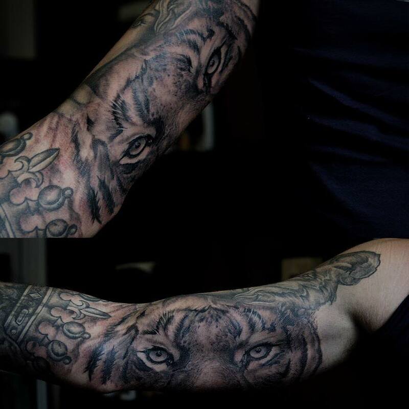 lion eye tiger animal realism tattoo, upper arm masculine tattoo black and grey